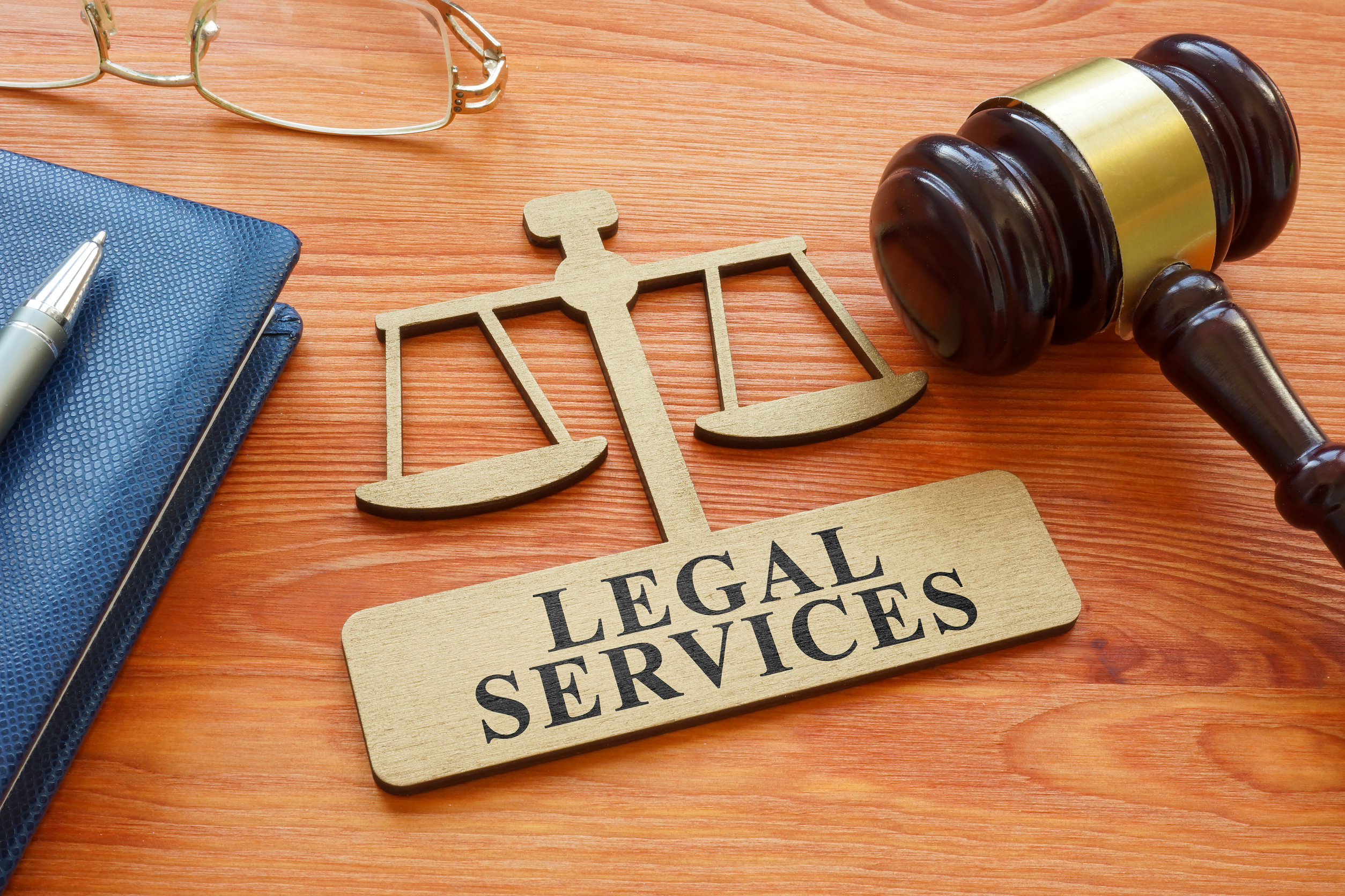 A Gavel and scale model with inscription legal services